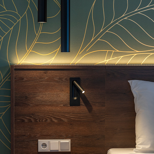 Atmospheric lighting above a comfortable bed