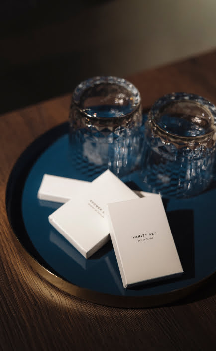 A scene showing a tray with a vanity set and two glasses.